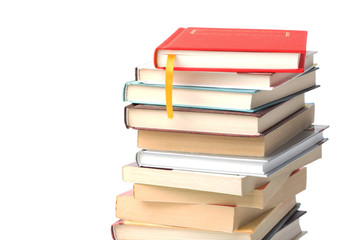 Stack of different books with book  with yellow bookmark on its top isolated on a white background