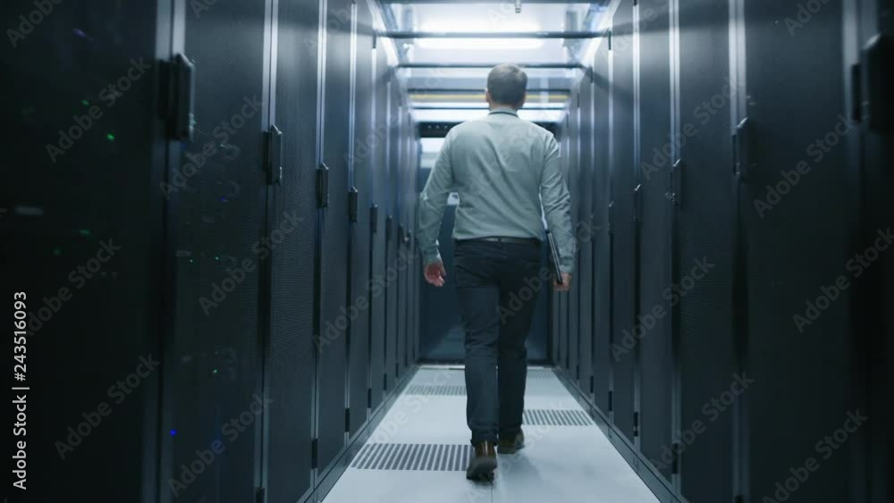 Leinwandbilder Walking Through Data Center IT Engineer Stops Before Working Server Rack to Do Routine Maintenance Check Using Laptop. Concept of Cloud Computing, Artificial Intelligence, Supercomputer
