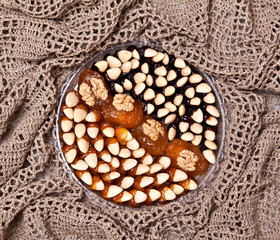Dried apricots, almonds with walnuts, laid out on a round plate like cake, Armenia, sweets of Armenia