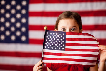 Girl Peeking from Behind American Flag