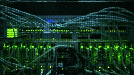 Close-up Shot In Data Center: Insides of the Working Server Rack Showing Hardware Equipment, Fiber Optic Broadband Cables, Blinking LED Lights.