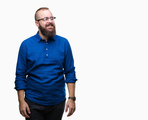 Fototapeta premium Young caucasian hipster man wearing glasses over isolated background looking away to side with smile on face, natural expression. Laughing confident.