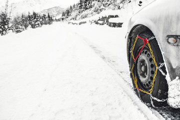 Car with mounted snow chains in wintry environment
