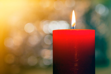 Candles light. Christmas candle burning at night. Abstract candle background. Golden light of...