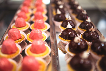 chocolate and strawberry desserts displayed in a display case
