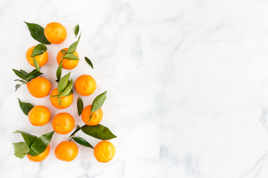Arrangement of Clementines on White Marble Background © tinasdreamworld