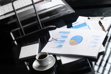 stack of financial documents and a Cup of coffee close-up