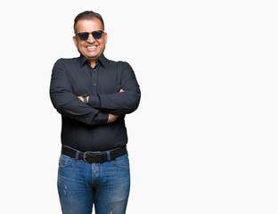 Fototapeta premium Middle age arab man wearing sunglasses over isolated background happy face smiling with crossed arms looking at the camera. Positive person.