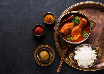 Indian dish chicken spicy curry masala. Spicy chicken legs with rice