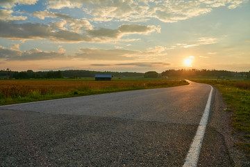 Empty countryside road between fields