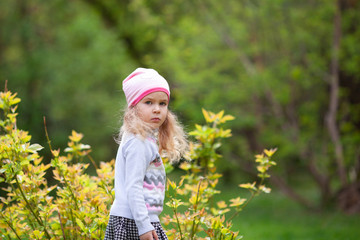 Little cute girl walking in summer park, outdoor