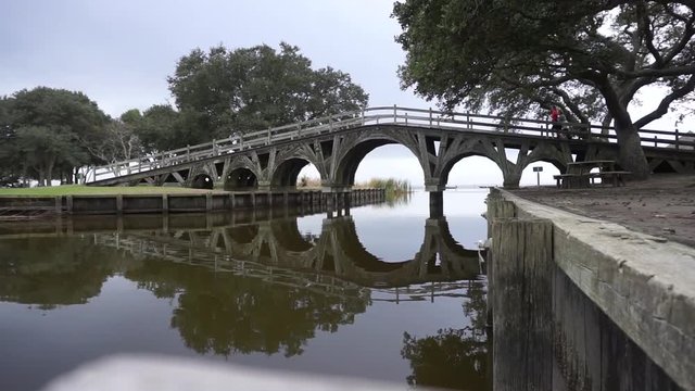 People walk accross historic bridge near the village of duck on the outerbanks of North Carolina.