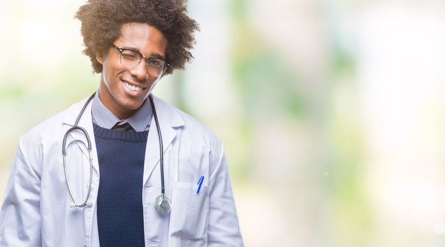 Afro american doctor man over isolated background winking looking at the camera with sexy expression, cheerful and happy face.