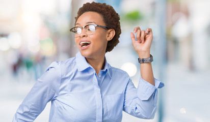 Young beautiful african american business woman over isolated background Dancing happy and cheerful, smiling moving casual and confident listening to music