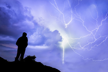 Silhouette of a man in front of a storm