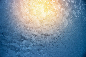 Frosty natural pattern and sun on winter window
