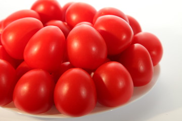 Tomatoes bunch on white plate