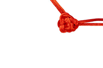 Small red valentine knot made from decorative cord. Macrame.