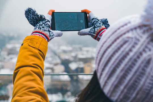 tourist woman taking selfie of winter city