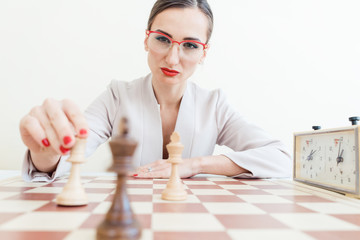 Businesswoman making strategic move in game of chess