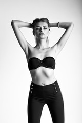 Fototapeta na wymiar Beautiful girl in black bra and leggins on white background