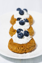 pumpkin cakes with cream and blueberries, vertical