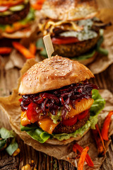Vegan burgers, carrot burger, homemade burger with carrot cutlet, grilled bell pepper, cherry...