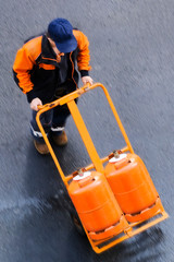 delivery worker with gas butane bottles ,  lpg gpl