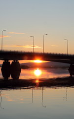 Midnight sun shining under the bridge in Rovaniemi, Finland