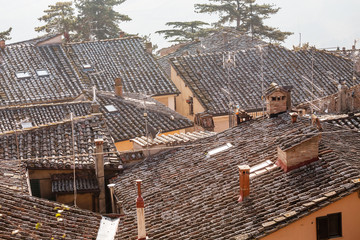 view of tiled roofs of old town in Tuscany, Italy.