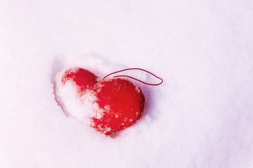 Red plush heart in snow, Valentines day concept