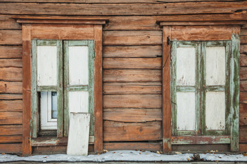 windows of a wooden house in spring in Siberia