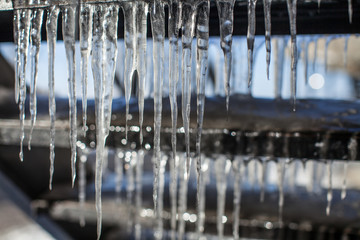 dangerous stairs cover with icicles during a thaw