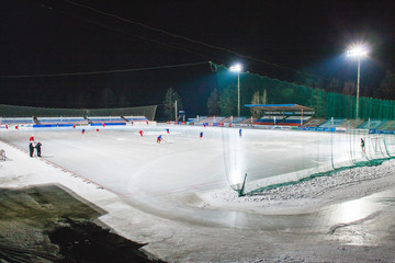 Fototapeta na wymiar an open air hockey stadium game in winter in Siberia