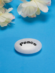 White flowers with a stone that depicts tranquility and peace.