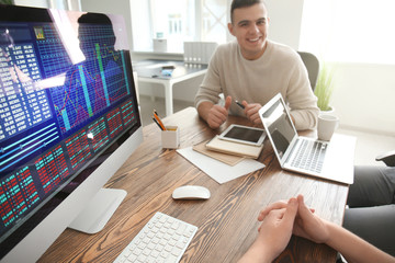 Young men working in office