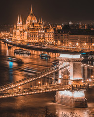 Fototapeta na wymiar Panorama of the Hungarian Parliament, and the Szechenyi Chain bridge over the River Danube, Budapest, Hungary, at night