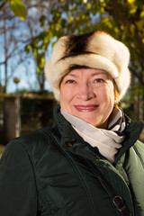 Closeup portrait of mature woman in autumn park