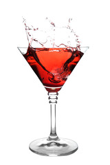 Glass of martini cocktail with splash on white background