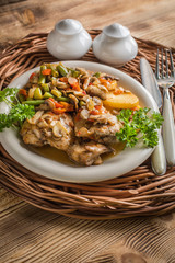Fillet of chicken legs with stewed vegetables.