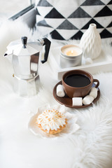 Cozy white winter home arrangement on windowsill, coffee and swe