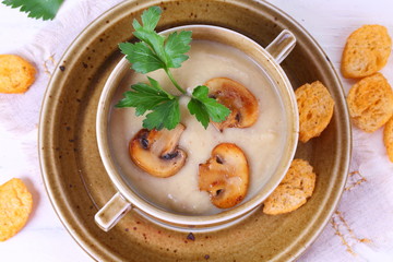 mushroom soup puree with crackers on a wooden table
