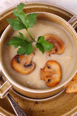 mushroom soup puree with crackers on a wooden table