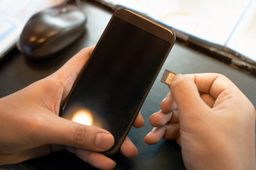 Employees are putting nano SIM cards in the store for customers to buy.