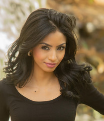 Beautiful young woman with long dark hair and exotic facial features.