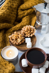 Warm home arrangement on windowsill, coffee and cookies with can