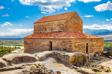 Beautuful View to Ancient Orthodox historic Church in antique cave city Uplistsikhe. The Uplistsikhe 9th-10th century three-nave basilica and vale of Mtkvari river, Shida Kartli, Gori, Georgia.