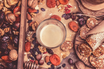 coffee and dried fruits. heart-healthy foods, dried apricots, nuts, homemade sweets of oatmeal. Retro toned background
