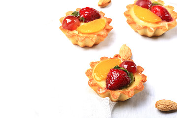 almond cake with berries on white background