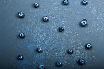blueberry berries on a dark blue background. beautiful autumn background